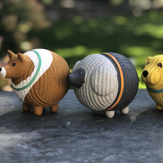 Set of three squeaky latex ball dog toys side view: grey poodle with orange collar, yellow golden retriever with blue collar, and brown and white collie with green collar. Golden retriever mostly out of frame.