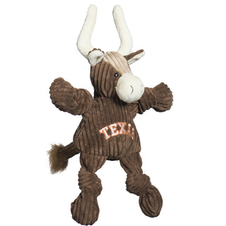 Side view of Texas Longhorn durable plush corduroy dog toy with knotted limbs, brown body, tan forehead, long white horns, brown fluffy end of tail, and "Texas" embroidered in downward curved style in white with orange boarder on front chest. Size small.