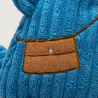 Close-up of satchel. Brown flap with a white button closure. Thumbnail
