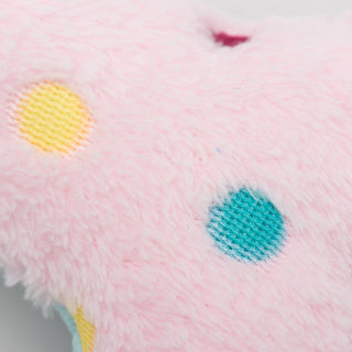 Close up view of light pink faux-fur side with multicolored polka dots.