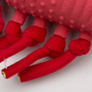 Close up image of lobster shaped durable plush dog toy legs: showing one side of the lobsters four knotted legs and how they pass through the latex body.