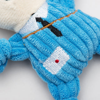 Close up of tiny plush corduroy dog toy mail carrier body showing detail of embroidered tie and envelope.