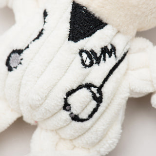Close up of tiny plush corduroy dog toy veterinarian body showing detail of stethoscope.
