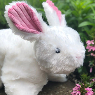 Close up view to show texture of fluffy white fabric and pink corduroy ears.