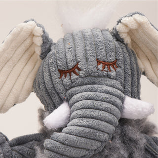 Close up of elephant shaped durable plush dog toy face with grey fluffy HuggleFleece® body, white hair, white inner-ear, and white tusks.