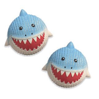 Set of two squeaky ball shaped shark dog toy: with blue skin, black eyes, white pupils, black nose, red mouth, white teeth, and a white stomach.