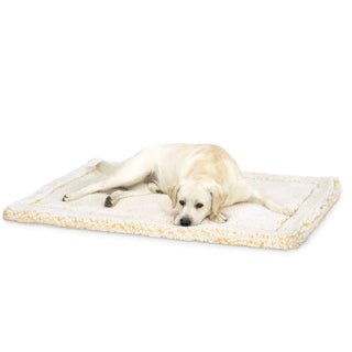Yellow lab laying on natural colored mat.