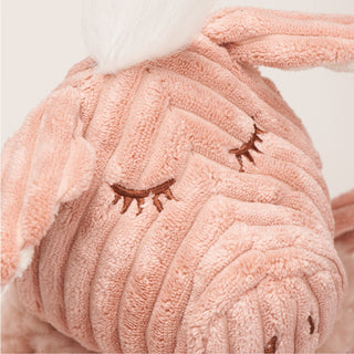 Close up view of embroidered closed eyes.