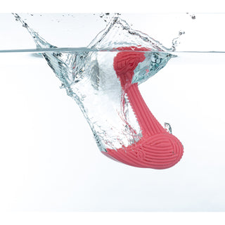 Pink dog bone chew toy in the shape of an "L", with textured ridges all throughout the toy resembling corduroy texture in water to show that it floats.
