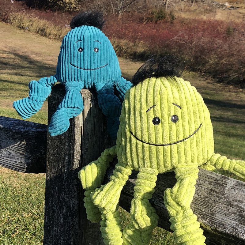 Lifestyle of Octavie Octopus Knotties- on a wooden fence.
