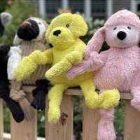 Lifestyle picture of Diva Pink Poodle Knottie. Pictured together with other dog Knotties on a wooden fence. Thumbnail