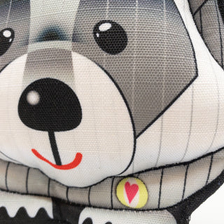 Close up of raccoon plush dog toy to show details.