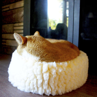 Cat sleeping in XS sized natural colored HuggleFleece® dog/cat bed.