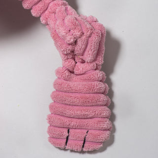 Close up of knotted limb on pink bunny durable plush corduroy dog toy.