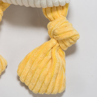 Close up of yellow knotted limb of durable plush corduroy dog toy.