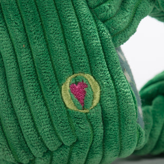 Close up image of the HuggleGroup heart on the bottom right side on the frog shaped plush. 