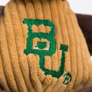 Close up of Baylor University Bruiser the Bear mascot durable plush corduroy dog toy gold shirt with embroidered Baylor University logo on the front.