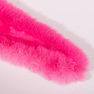 Close up view of magenta fluffy tail on Axolotl dog toy. 