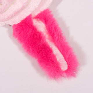 Close up view of small light-pink axolotl plush dog toy tail. Has light pink tail with a dark pink furred outer-tail. 