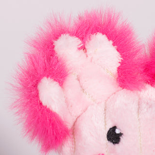 Close up view of light pink fured axolotl face and left ear, Has light-pink fur, black eyes, white pupils, and dark pink outer-ear. 