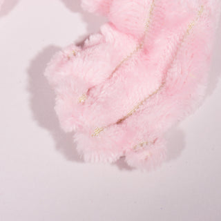 Close up view of light-pink furred axolotl hand. 