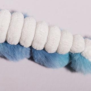 Close up view of the inner-tenticle of the octopus shaped blue and fluffy plush dog toy. The inner-tenticle is white and fluffy.