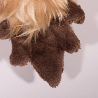 Close up view of brown and soft tail on duck shaped plush dog toy. 