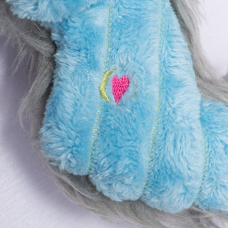 Zoomed-in detail of pink embroidered HuggleHeart on Snobro's blue plush body, symbolizing love and quality.
