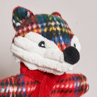 Close-up of Jolly Jax Fox dog toy showing red plaid scarf and holiday design details.