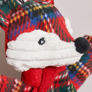 Close-up of Jolly Jax Fox dog toy showing red plaid scarf and holiday design details with white corduroy face