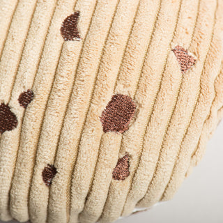 Close up of tan cookie with brown embroidered chips.