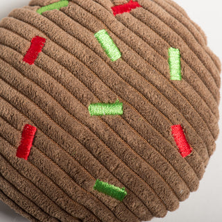 Close up of brown cookie with red and green sprinkle. 