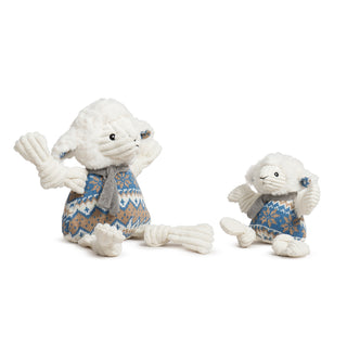 Two plush lamb toys wearing knitted sweaters on a white background