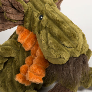Close-up of Milo Moose's face showing plush antlers, black eyes, brown beard, and orange fuzzy scarf.

