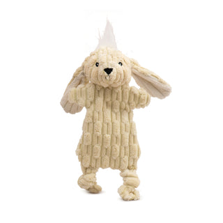 Pale yellow bunny dog toy with minimal stuffing and white inner ears, white hair tuft on head, knotted legs, and black embroidered facial details.