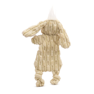 Back view of pale yellow bunny plush dog toy with white hair tuft on top of head.