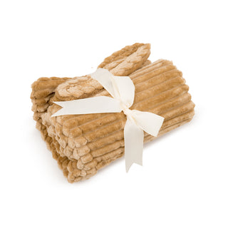 Natural colored scout blanket rolled up and wrapped with a white ribbon. 