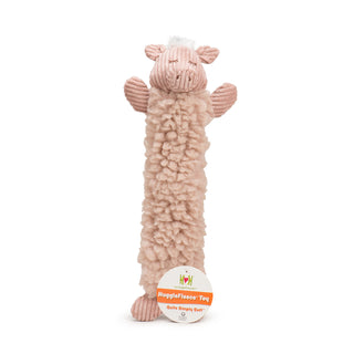 Elongated pig plush dog toy with dusty pink colored HuggleFleece® body, white hair tuft on top of head, dusty pink corduroy face, ears, arms, and legs, and brown embroidered nose and closed eyes with tag.