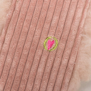 Close up of embroidered HuggleHeart logo on back of Penelope Pig Fluffer Long & Lovelie™.