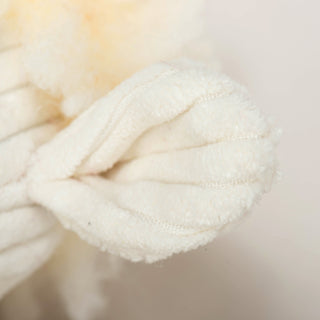 Close up of white corduroy ear on Louise Lamb Fluffer Long & Lovelie™.