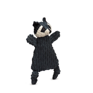 Side view of dark gray triangle shaped raccoon corduroy plush dog toy with white face, black inner ears and around eyes, dark gray strip down forehead, knotted legs, short stubby arms, and brown embroidered eyes.