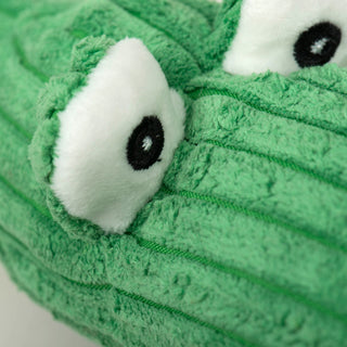 Close up picture of the large eyes on the snakes.  The eyes are big white circles with embroidered black pupils with white center.  The face of the snake is bright green corduroy plush fabric. 