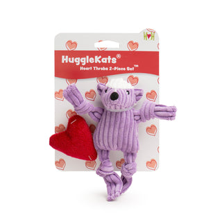 Picture of the 2 pack HuggleKats Heart Throb set.  The picture shows the purple corduroy tiny skunk with knotted arms and legs and a plush red heart pillow.  Both toys are attached to a card that says HuggleKats Heart Throbs 2-piece set.  The card has small printed hearts all over it.