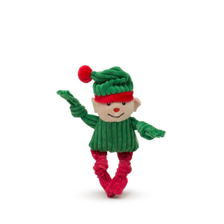 Elf Wee Huggle plush corduroy dog toy with knotted limbs, red legs, green body and arms, pale skin-tone face, green hat with red details, and red embroidered nose with black embroidered eyes and mouth.