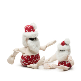 Set of two Beach Bum Santa Knottie® plush dog toys in large and small: pale skin tone body with knotted limbs, red nordic print bathing suit and hat, fluffy white beard and trim on hat, and black embroidered sunglasses.