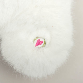 Close up of HuggleHeart logo on white faux-fur to show texture of fabric.