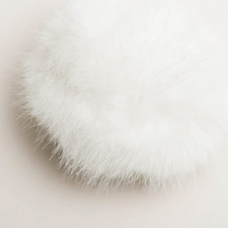 Close up of white fluffy faux-fur plush snowball for cats.