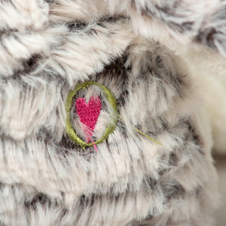 Close up of HuggleHeart logo on Ursa penguin to show texture of fluffy gray faux-fur.