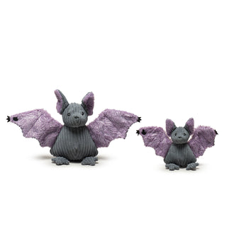 Set of two gray and purple bat plush dog toys with wings opened in large and small sizes: gray corduroy body, head, feet, and outside of ears, purple swirly sparkle fuzzy fabric on inside of wings and ears, black hands on the ends of each wing, and embroidered facial details.