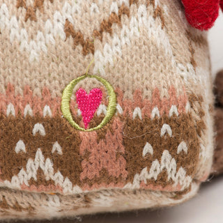 Close up of Cinnamon Horse Knottie® sweater texture and embroidered HuggleHeart logo.